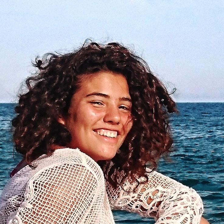 Aisha Raman, Lead Design Curator at Fuzzy Portal Vista, reviewing corporate floral arrangements